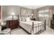 Comfortable bedroom featuring a metal frame bed, neutral decor, and tile flooring at 7436 E Chaparral Rd # 124B, Scottsdale, AZ 85250