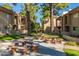 Charming courtyard with outdoor seating under mature trees, perfect for picnics or relaxation at 7436 E Chaparral Rd # 124B, Scottsdale, AZ 85250