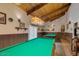 The game room has 2 billiard tables, a wood ceiling, wainscotting, and unique lighting for entertaining at 7436 E Chaparral Rd # 124B, Scottsdale, AZ 85250