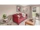 Comfortable living room with a red sofa, complemented by bright light, and tile floors at 7436 E Chaparral Rd # 124B, Scottsdale, AZ 85250