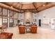 The lobby features a brick fireplace, wood ceiling, tile flooring, and plenty of comfortable seating for guests at 7436 E Chaparral Rd # 124B, Scottsdale, AZ 85250