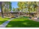 Beautiful pool area with shaded pergola, lounge chairs, and well-manicured landscaping at 7436 E Chaparral Rd # 124B, Scottsdale, AZ 85250