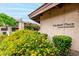 A welcoming entrance sign for Winfield Place Condominiums is framed by colorful flowers and manicured landscaping at 7436 E Chaparral Rd # 124B, Scottsdale, AZ 85250