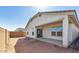 Rear view of the home highlighting the backyard with covered patio at 7718 W Minton St, Laveen, AZ 85339