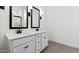 Elegant bathroom with dual sinks, sleek black fixtures, and modern design at 7718 W Minton St, Laveen, AZ 85339
