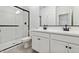 Modern bathroom featuring double sinks and a glass-enclosed shower with marble-style tile at 7718 W Minton St, Laveen, AZ 85339