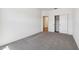 Neutral bedroom with a double door closet and gray carpet at 7718 W Minton St, Laveen, AZ 85339