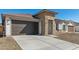 Attractive home with stone accents, a brown garage door, and a convenient concrete driveway at 7718 W Minton St, Laveen, AZ 85339
