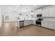 Bright kitchen showcases stainless steel appliances, white cabinets, and an open layout with ample counter space at 7718 W Minton St, Laveen, AZ 85339