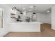 Modern kitchen boasting white cabinetry, a large island with seating, and trendy pendant lighting at 7718 W Minton St, Laveen, AZ 85339