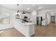 Well-lit kitchen featuring white cabinetry, stainless steel appliances, and a spacious center island at 7718 W Minton St, Laveen, AZ 85339