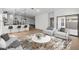 Open-concept living area with stylish seating, a decorative rug, and seamless access to the kitchen and dining at 7718 W Minton St, Laveen, AZ 85339