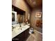 Unique bathroom featuring dark cabinetry, creative decor and custom finishes at 8180 E Shea Blvd # 1028, Scottsdale, AZ 85260