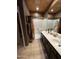 Well-lit bathroom featuring a double vanity, shower, and tiled floors creating a spa-like retreat at 8180 E Shea Blvd # 1028, Scottsdale, AZ 85260