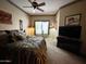 Comfortable bedroom featuring a ceiling fan, large bed, and decorative accents for a cozy atmosphere at 8180 E Shea Blvd # 1028, Scottsdale, AZ 85260