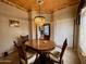 A beautifully decorated dining area with a chandelier hanging above the glossy dining table at 8180 E Shea Blvd # 1028, Scottsdale, AZ 85260