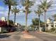 Gated community entrance with lush landscaping, palm trees, and well-maintained grounds at 8180 E Shea Blvd # 1028, Scottsdale, AZ 85260