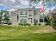 Two-story building featuring green shutters, a manicured lawn, and decorative shrubbery at 8180 E Shea Blvd # 1028, Scottsdale, AZ 85260