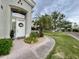 Charming home featuring a white door, desert landscaping, mature trees, and a well manicured lawn at 8180 E Shea Blvd # 1028, Scottsdale, AZ 85260