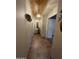 Hallway featuring neutral walls and tile flooring, adorned with elegant lighting fixtures at 8180 E Shea Blvd # 1028, Scottsdale, AZ 85260