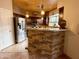 Charming kitchen featuring stainless steel appliances, tile flooring, and stacked stone breakfast bar at 8180 E Shea Blvd # 1028, Scottsdale, AZ 85260
