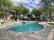 Refreshing community pool surrounded by travertine tile and landscaping, perfect for relaxation at 8180 E Shea Blvd # 1028, Scottsdale, AZ 85260