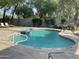 Community pool with lounge chairs and trees at 8180 E Shea Blvd # 1028, Scottsdale, AZ 85260