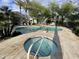 Beautiful community pool with a separate hot tub, featuring travertine tile and well-maintained landscaping at 8180 E Shea Blvd # 1028, Scottsdale, AZ 85260