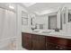 Bathroom showcases a double vanity with sink, large mirror, and a shower at 8545 E Heatherbrae Dr, Scottsdale, AZ 85251