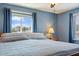Bright bedroom features soft blue walls, wood furnishings, and a scenic window view at 8545 E Heatherbrae Dr, Scottsdale, AZ 85251