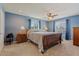 Bedroom features soft blue walls, wood furnishings, and plenty of natural light at 8545 E Heatherbrae Dr, Scottsdale, AZ 85251