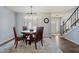 Dining area with seating for four, a modern light fixture and laminate floors at 8545 E Heatherbrae Dr, Scottsdale, AZ 85251