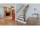 Staircase with wrought iron spindles next to the living room fireplace at 8545 E Heatherbrae Dr, Scottsdale, AZ 85251