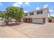 Home exterior featuring two-story design, driveway, lush tree, and well-kept landscaping at 8545 E Heatherbrae Dr, Scottsdale, AZ 85251