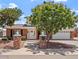 Charming two-story home with brick accents, a lush tree, and a well-manicured front yard at 8545 E Heatherbrae Dr, Scottsdale, AZ 85251