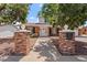 Inviting home exterior with brick columns, a walkway and mature shade trees at 8545 E Heatherbrae Dr, Scottsdale, AZ 85251
