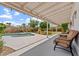 Relaxing covered patio overlooking the sparkling pool and meticulously maintained backyard at 8545 E Heatherbrae Dr, Scottsdale, AZ 85251