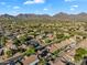 Expansive community with well-maintained homes and desert landscaping, set against a backdrop of stunning mountains at 9127 E Siesta Ln, Scottsdale, AZ 85255