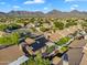 A beautiful community and lush landscaping with mountains in the distance at 9127 E Siesta Ln, Scottsdale, AZ 85255