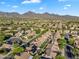 Residential community featuring well-maintained homes, lush trees, and mountain views in the background at 9127 E Siesta Ln, Scottsdale, AZ 85255