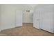 Bedroom with tile flooring, a closet, and a view of the hall area at 9127 E Siesta Ln, Scottsdale, AZ 85255