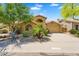 Charming single-story home featuring a tile roof, desert landscaping, and a spacious driveway at 9127 E Siesta Ln, Scottsdale, AZ 85255