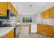 Bright kitchen with wood cabinets, modern appliances, and a view of the backyard at 9127 E Siesta Ln, Scottsdale, AZ 85255