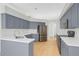 Modern kitchen boasts stainless steel appliances, custom grey cabinets, and white countertops at 9127 E Siesta Ln, Scottsdale, AZ 85255