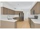Modern kitchen boasts stainless steel appliances, custom cabinets, and white countertops at 9127 E Siesta Ln, Scottsdale, AZ 85255