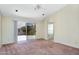 Bright main bedroom with sliding glass door leading to patio and an arched entry to the bathroom at 9127 E Siesta Ln, Scottsdale, AZ 85255