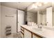 Bathroom with vanity, sink, mirror, tile floors and walk-in shower at 9511 W Carol Ave, Peoria, AZ 85345