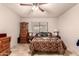 Bedroom featuring tile floors, ceiling fan, and ample natural light from window at 9511 W Carol Ave, Peoria, AZ 85345