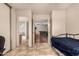 A bedroom with tile flooring, a view of the bathroom, living room, and closet at 9511 W Carol Ave, Peoria, AZ 85345