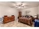Cozy bedroom with a ceiling fan, natural light, and tile flooring at 9511 W Carol Ave, Peoria, AZ 85345